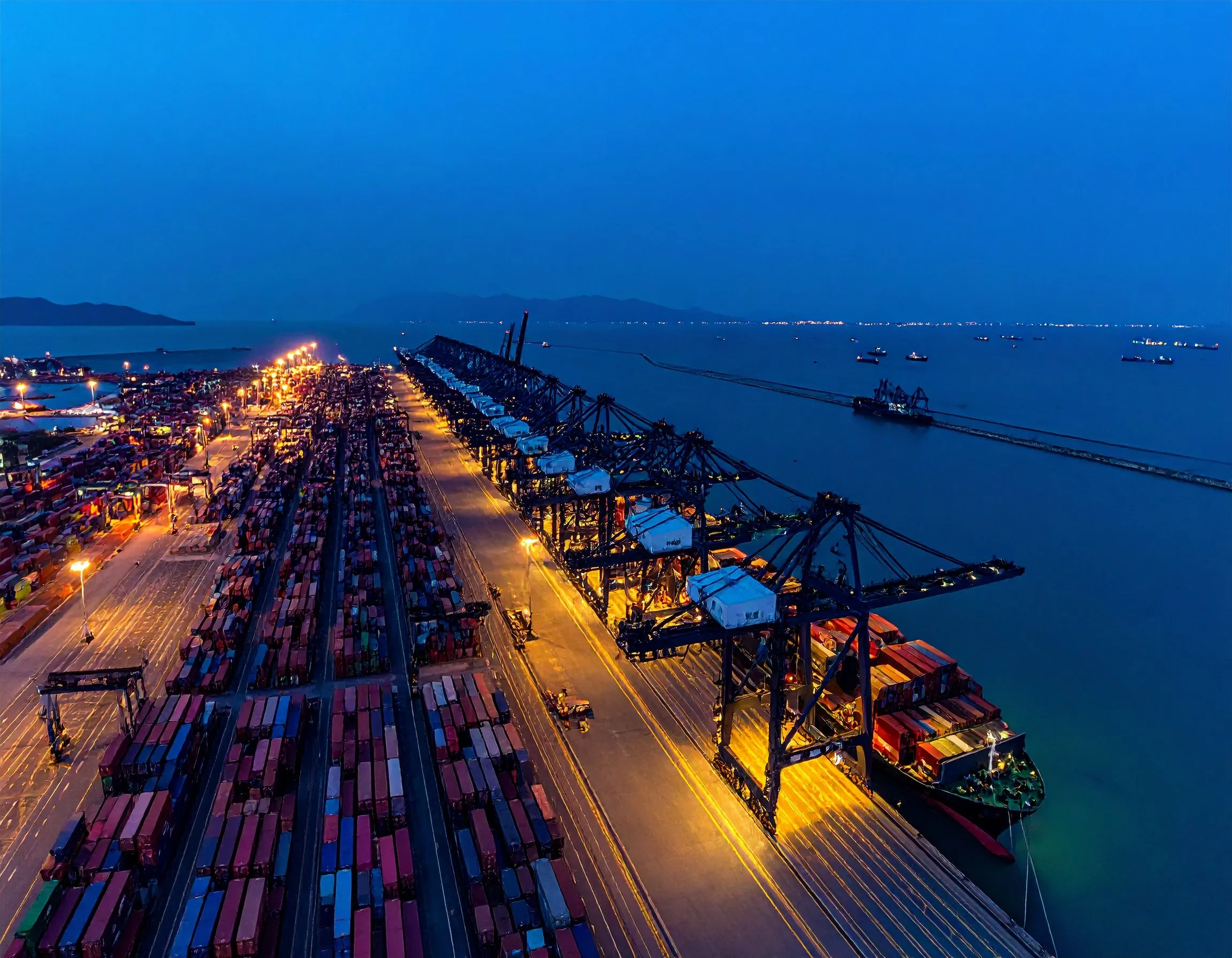 Container terminal with a vessel at berth at dusk